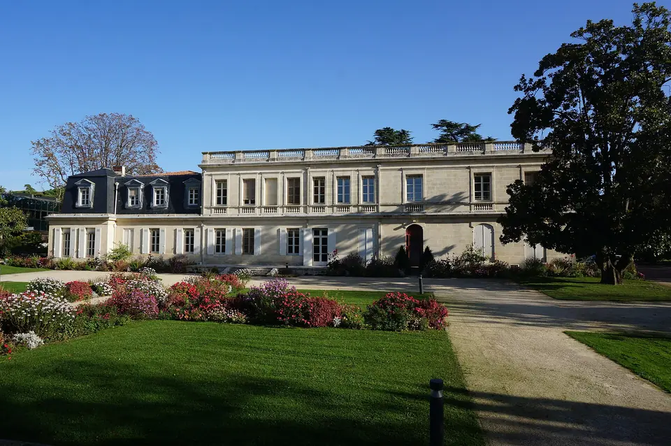 Hôtel de ville de Mérignac installé dans le château du Vivier, longue façade classique en pierre précédée d'un jardin fleuri.